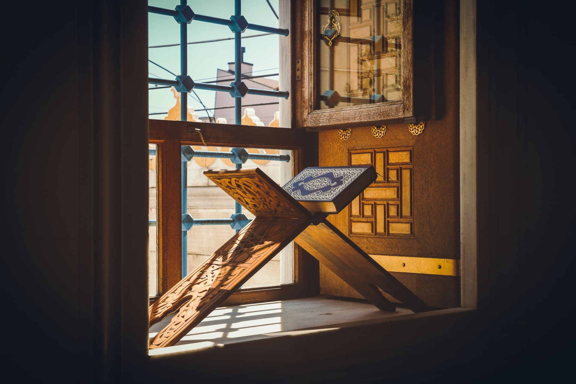 Quran on rehal by a sunlit window
